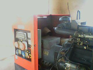 An open generator showing its electrical panel and internal components, indicating repair or maintenance by Alexco Max Electricals And Construction in Madina, GH.