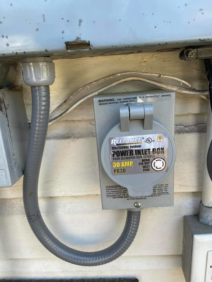 A close-up of a Reliance generator power inlet box installation by Mcgehee Electric, LLC in Montgomery, AL.