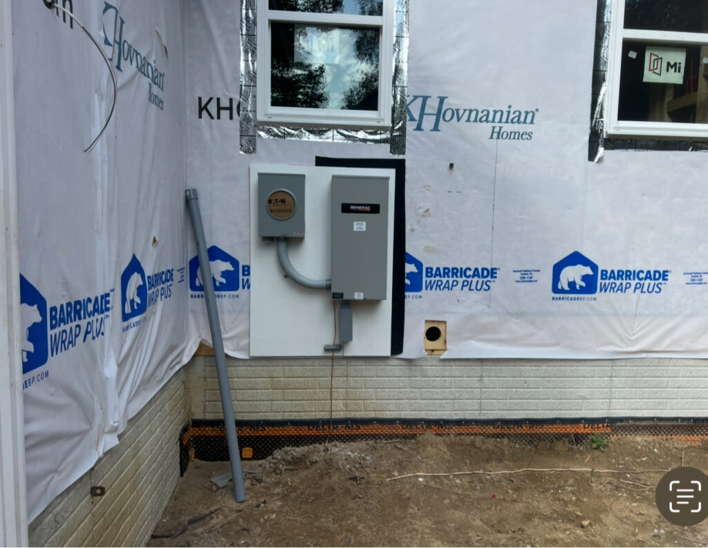 Exterior view of a house under construction with a generator transfer switch and electrical panel installed by Kouris Electric LLC in Canton, OH.