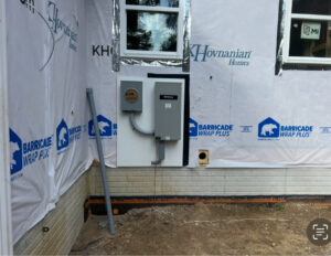 Exterior view of a house under construction with a generator transfer switch and electrical panel installed by Kouris Electric LLC in Canton, OH.