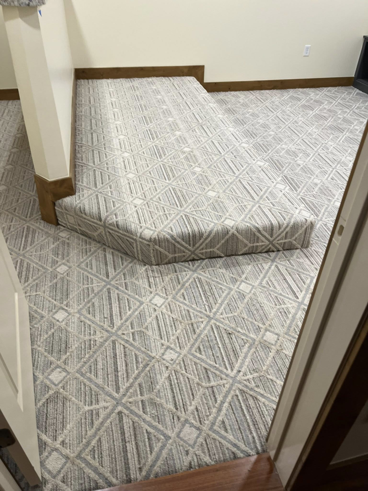 Geometric pattern carpet installed on a floor and steps by Flooring Liquidator in Orem, UT.