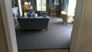 A living room featuring a large geometric pattern carpet installed by Carpet Art of America in O'Fallon, MO.