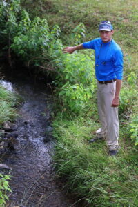 A GeoMosquito specialist inspecting a stream for potential pest breeding grounds in Roswell, GA