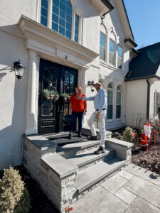 A GeoMosquito technician consulting with a customer about pest control services at a home in Roswell, GA