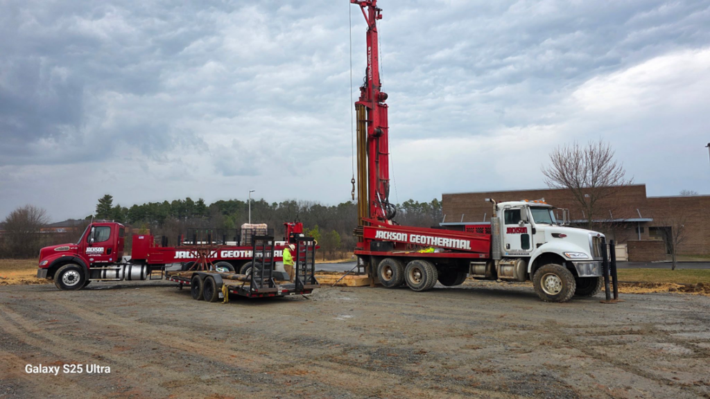Large geothermal drilling rig trucks and workers at a job site for Jackson Geothermal in Mansfield, OH.