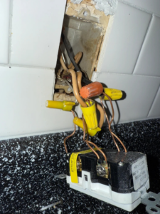 GFCI outlet wiring being installed or repaired by Ask Electricians in a kitchen in Los Angeles, CA.