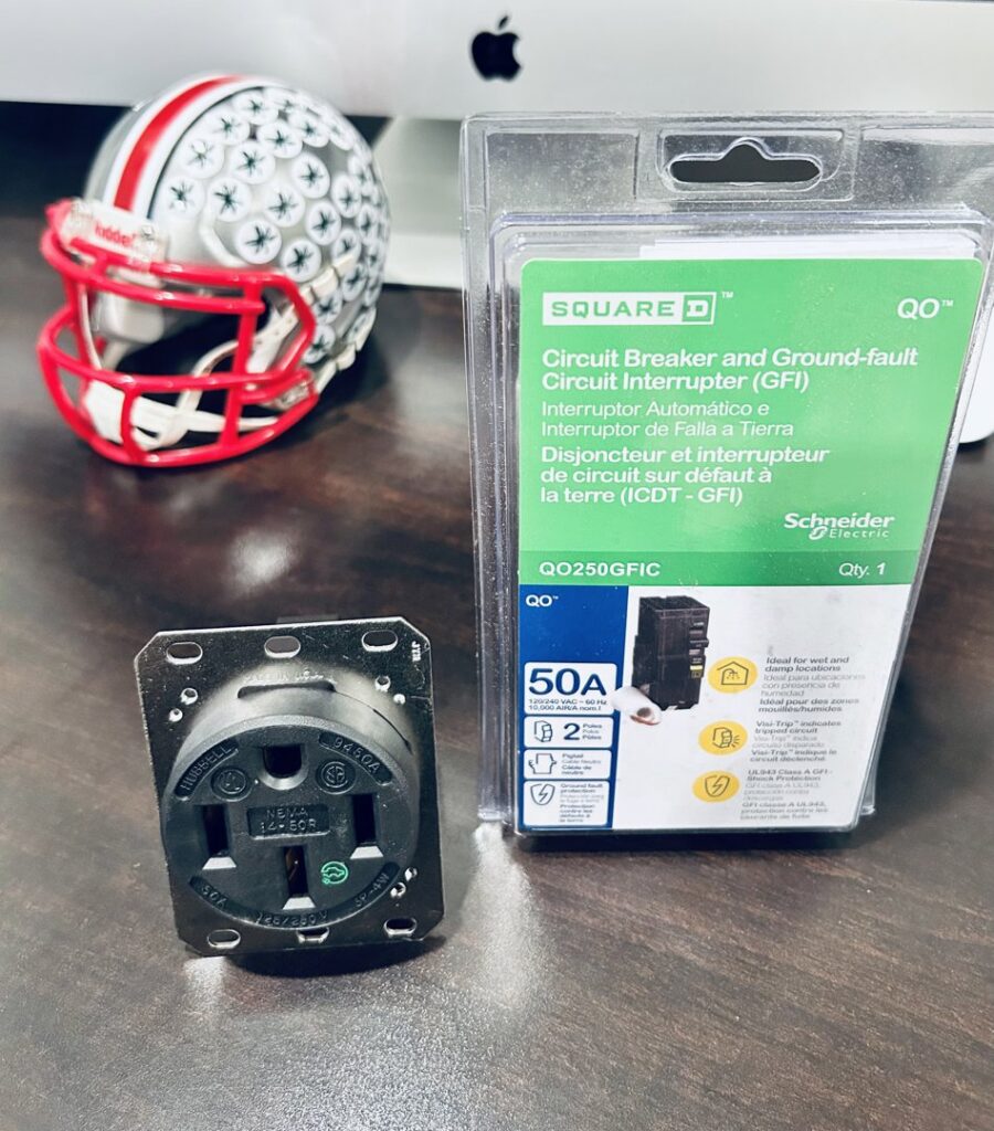 A GFI circuit breaker and a 50A electrical plug, essential components for electrical work by Surge Electric LLC in Youngstown, OH.