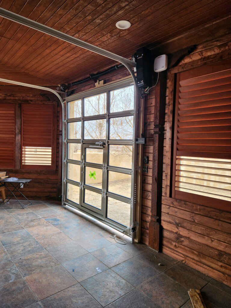 An interior view of a newly installed glass panel garage door by Prutch's Garage Door in Page, AZ