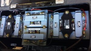 Close-up of golf cart batteries and wiring serviced by Advanced Golf & Electric Vehicles in Orlando, FL.