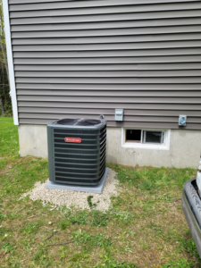 A newly installed Goodman outdoor AC unit next to a residential building by Mini Split Solutions in Austin, TX