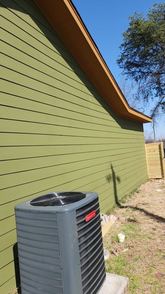 A newly installed Goodman outdoor AC unit next to a residential building by Summit Service Group in North Little Rock, AR.