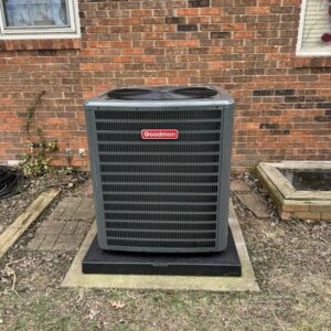A Goodman outdoor AC unit installed on a concrete pad at a residential property by Hodges Heating & Cooling in Owensboro, KY.