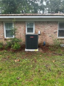 A Goodman air conditioning unit installed at a residential property by Zippers Heating and Cooling in Mobile, AL.