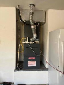 A Goodman furnace and air handler unit installed in a utility closet by One Hour Heating & Air Conditioning of West Valley in Phoenix, AZ