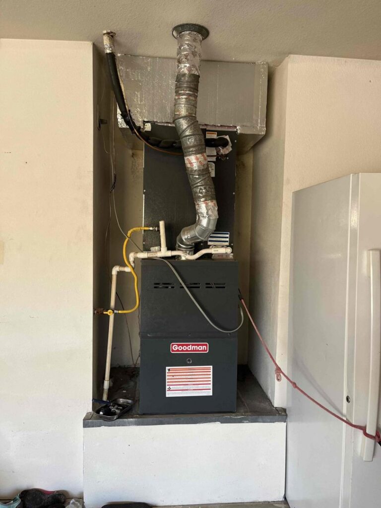 A Goodman furnace and air handler unit installed in a utility closet by One Hour Heating & Air Conditioning of West Valley in Phoenix, AZ