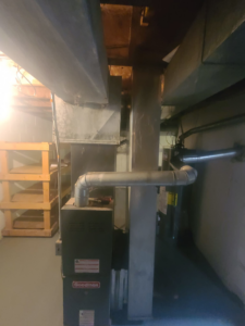 A Goodman furnace unit with extensive ductwork installed in a basement by Guzman Heating & Cooling in Milwaukee, WI.