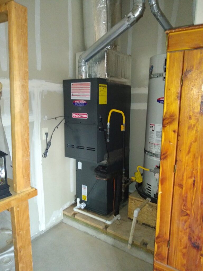 An indoor Goodman furnace and water heater installation with ductwork by Nevada Heating Reno in Sparks, NV.