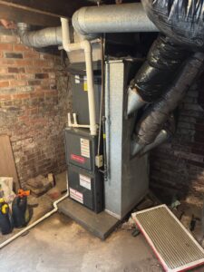 A Goodman furnace and air handler unit installed in a basement by Breezy Brothers Heating and Cooling in Lafayette, IN.