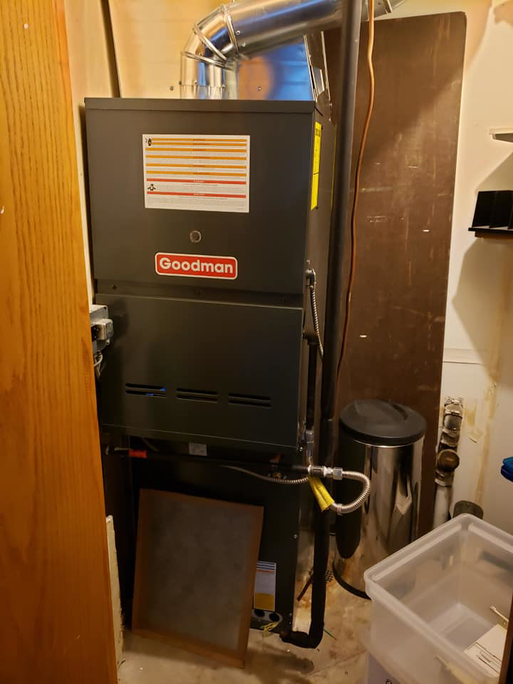 A Goodman furnace and air handler unit installed in a utility space by Atmosphere Mechanical Heating And Air / Ventilation in Aurora, CO.