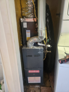 A Goodman furnace and air handler unit with ductwork installed by Bakes Heating and Cooling in Chatham, IL.