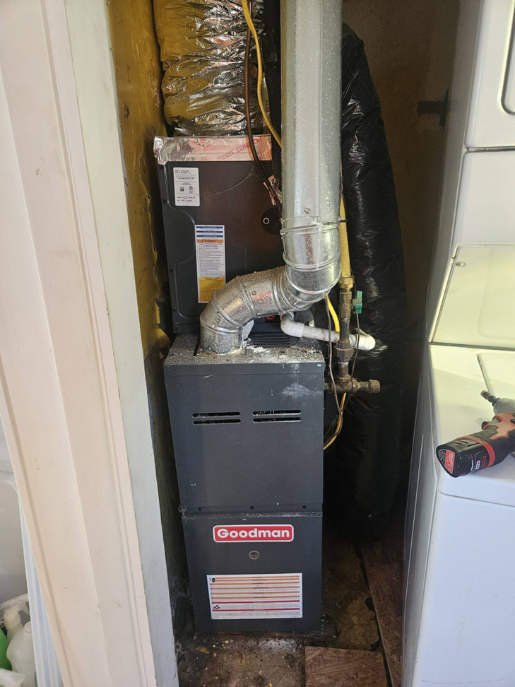 A Goodman furnace and air handler unit with ductwork installed by Bakes Heating and Cooling in Chatham, IL.