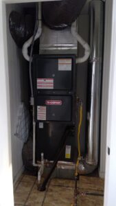 A Goodman brand furnace and air handler unit installed in a utility closet by Basic HVAC in Indianapolis, IN.