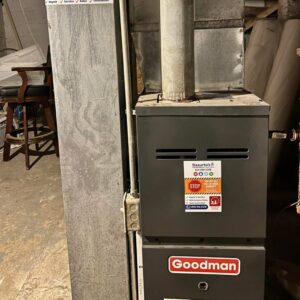 A newly installed Goodman furnace unit with Basurto's Heating & Cooling branding, located in Milwaukee, WI.