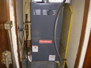 A Goodman furnace installed in a utility space by One Hour Heating & Air Conditioning of Springfield in Springfield, MO.
