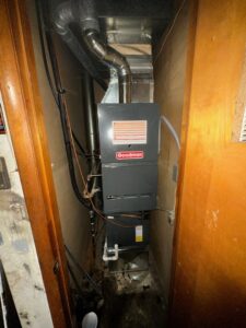 A Goodman furnace and air handler unit installed in a narrow utility space by Breezy Brothers Heating and Cooling in Lafayette, IN.