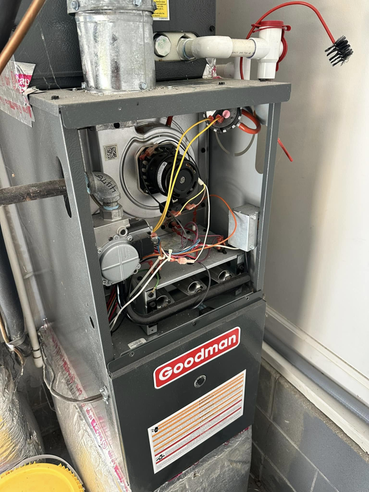 A Goodman furnace with its panel open, showing internal components during a repair by EndorFin Service's Inc. in Gloucester, VA.