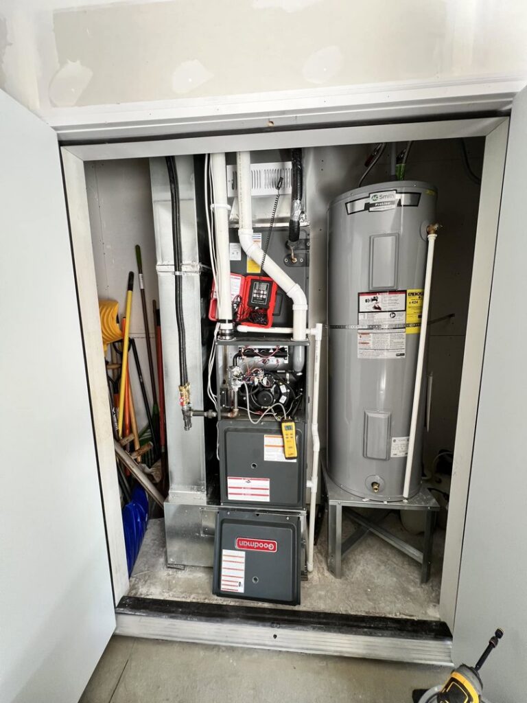 A Goodman furnace and water heater installed in a utility closet by Golden Heating and Air LLC in Arvada, CO.