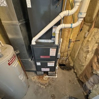 A Goodman furnace and water heater installed in a utility area, showcasing HVAC services by Lopez Mechanical HVAC in Kansas City, MO.