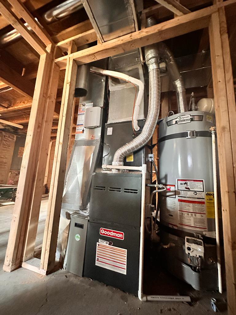 A new Goodman furnace and water heater installed in a utility space by LUCAS Heating And Air LLC in Salt Lake City, UT.