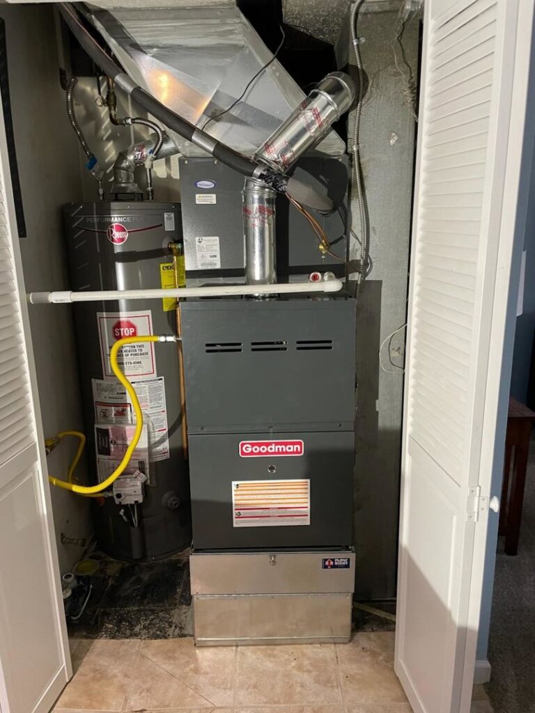 A new Goodman furnace and water heater installation inside a utility closet by National Heating & Cooling Company in Lakewood, CO.