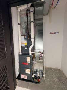 A newly installed Goodman HVAC furnace and air handler unit with ductwork by Fast Air in Zebulon, NC.