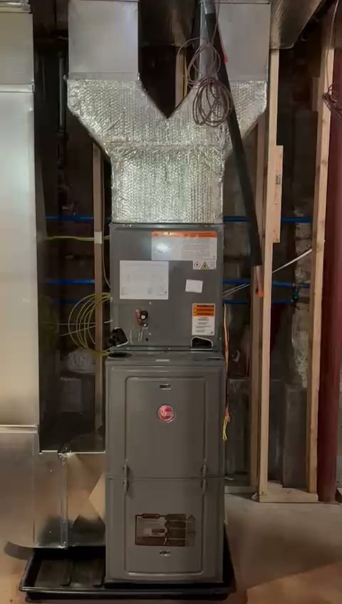 A Goodman HVAC furnace and air handler unit with ductwork installed in a utility closet by Fast Air in Zebulon, NC.