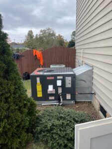 A new Goodman outdoor HVAC unit installed next to a residential home by Luciano's Air Services in Durham, NC.
