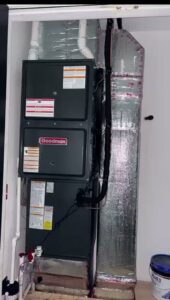 A Goodman HVAC system with ductwork installed in a utility closet by Fast Air in Zebulon, NC.