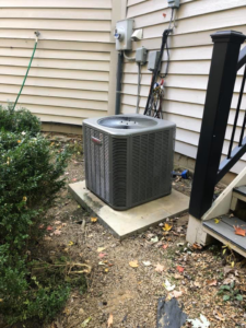 A Goodman HVAC outdoor unit installed next to a residential building by L.N.P Heating & Cooling in Columbus, OH