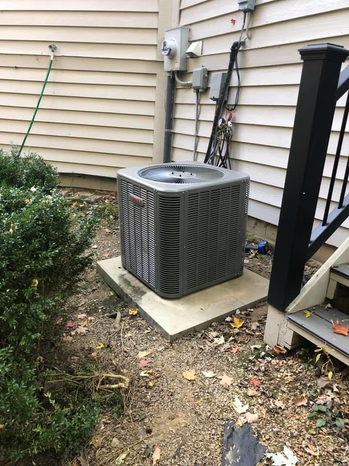 A Goodman HVAC outdoor unit installed next to a residential building by L.N.P Heating & Cooling in Columbus, OH