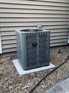 A Goodman outdoor air conditioning condenser unit installed by Elite Mechanical in Manchester, NH.