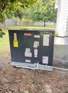 A Goodman outdoor AC unit from the back view, installed by CHIN Flower HVAC LLC in Murfreesboro, TN.