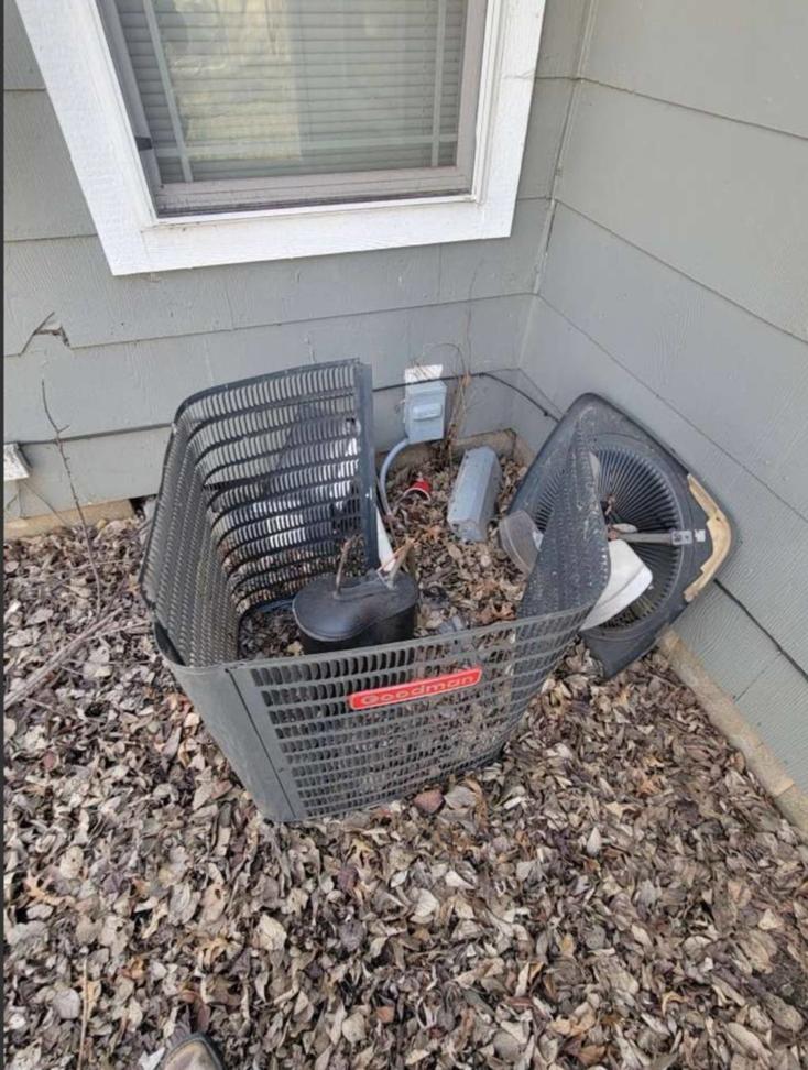 A Goodman outdoor air conditioning unit disassembled, showing internal components, by Friess Heating & Air Conditioning in Topeka, KS