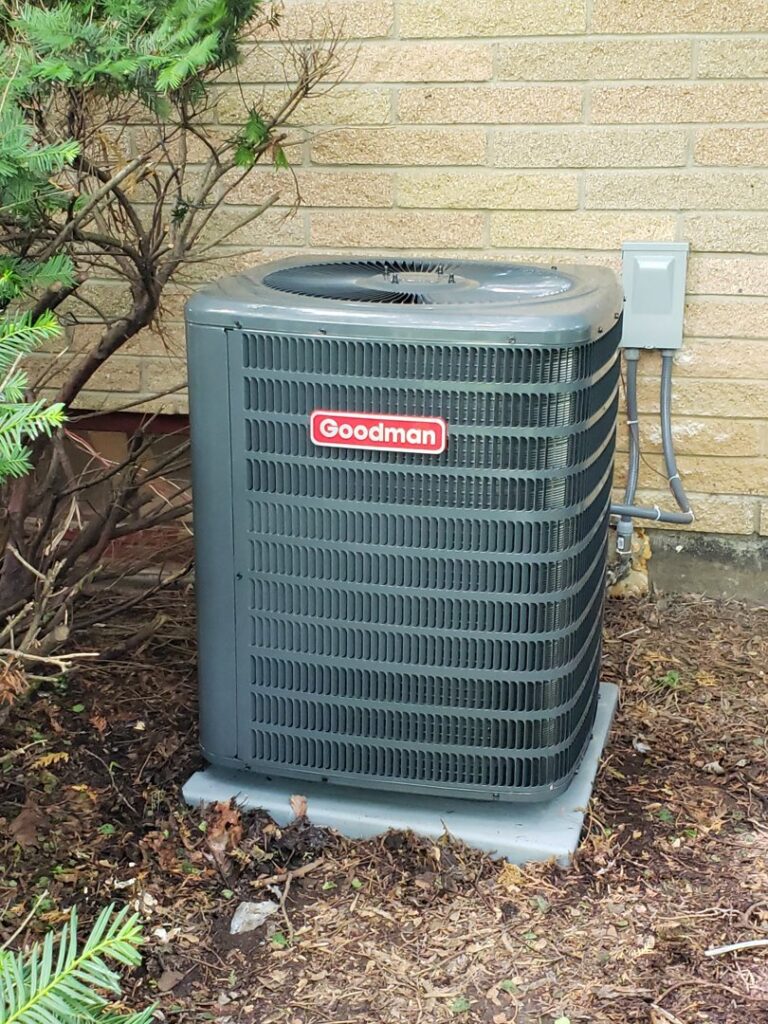 A newly installed Goodman outdoor air conditioning unit by 9-1-1 Heating & Air, LLC, providing cooling services in Milwaukee, WI.