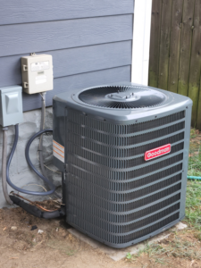 A newly installed Goodman outdoor air conditioning unit next to a home, serviced by HOP 2 IT LLC in Austin, TX.