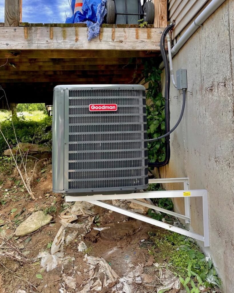 An outdoor Goodman air conditioning unit professionally installed on a bracket by Integrity Aire in St. Charles, MO.