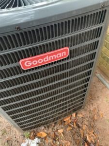 A close-up of a Goodman brand outdoor HVAC unit serviced by Comfort Breeze HVAC Refrigeration in Mobile, AL.