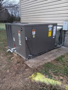 A Goodman outdoor HVAC unit installed next to a residential building by A/C Company Since 1988 in Murfreesboro, TN.