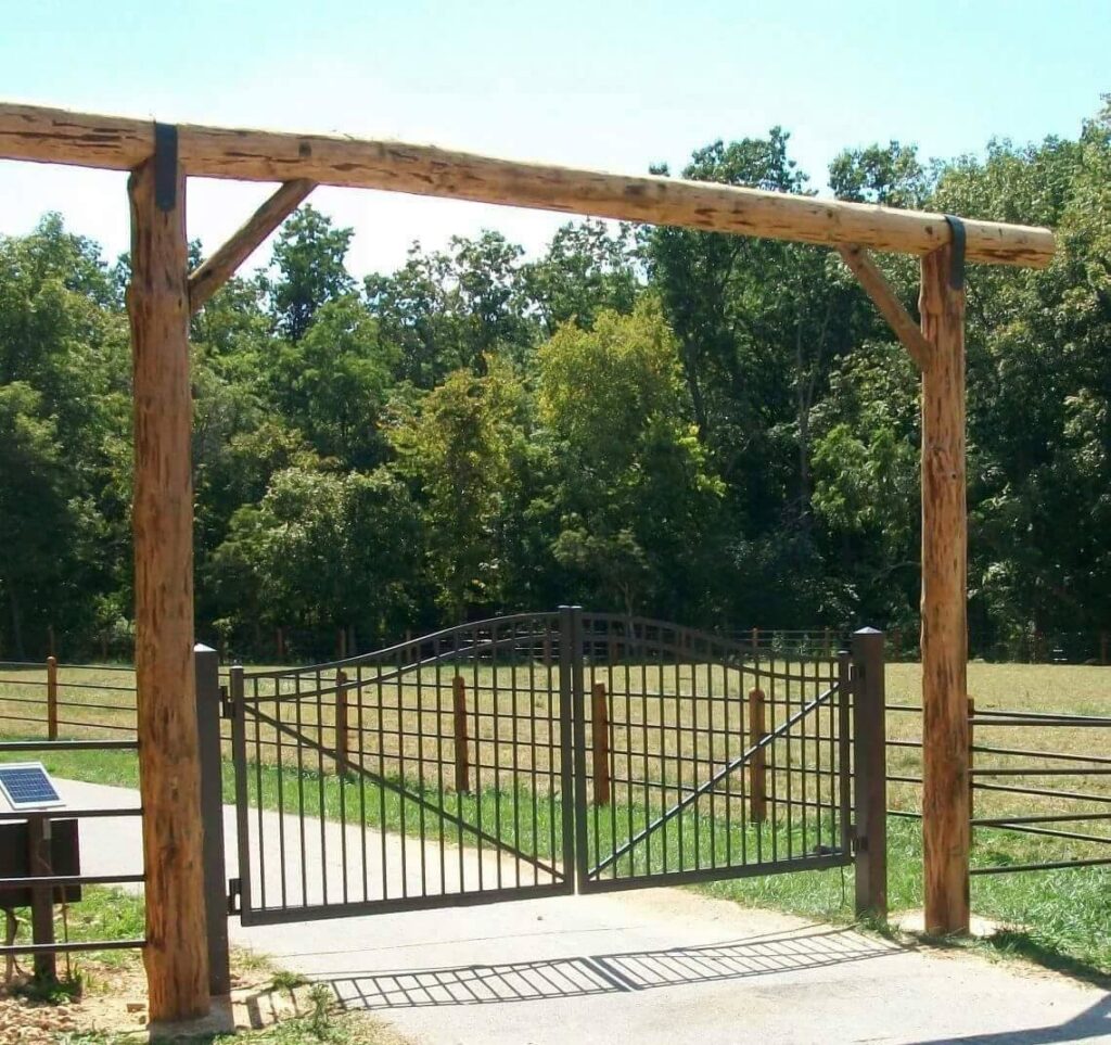 Grand wooden gate entrance with a metal gate installed by National Fence and Gate in Ironton, MO.