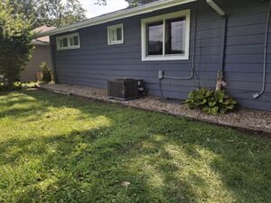 A neat gravel landscape bed along the side of a house by VKDYS Lawn Care in Fort Wayne, IN.